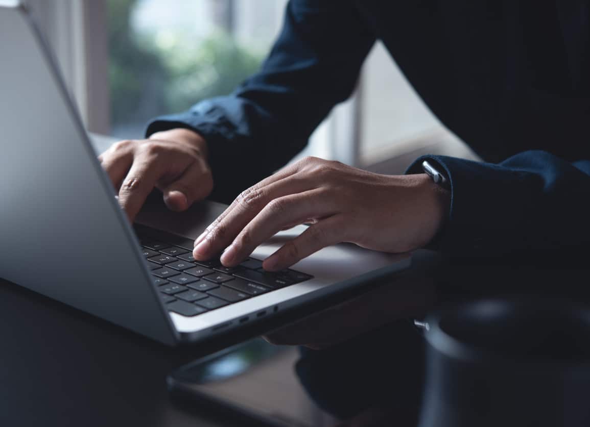 Businessman typing on laptop computer